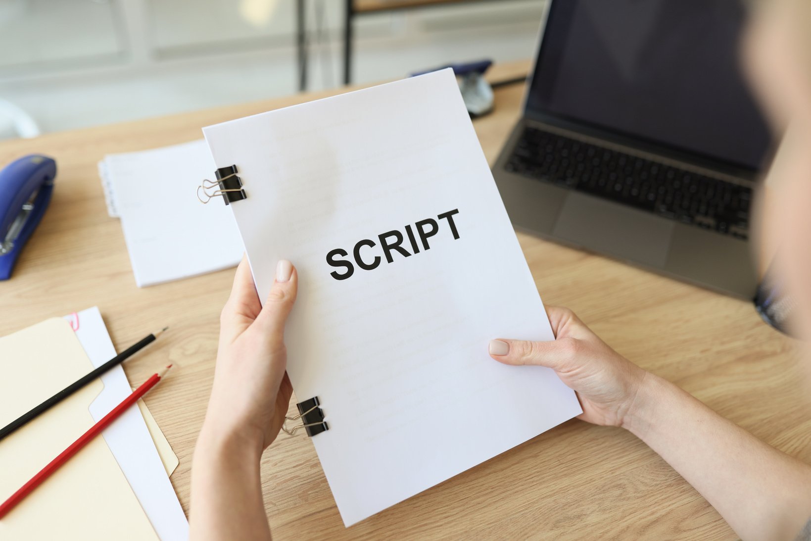 Hands of Woman Holding Script Papers for Movie in Hands